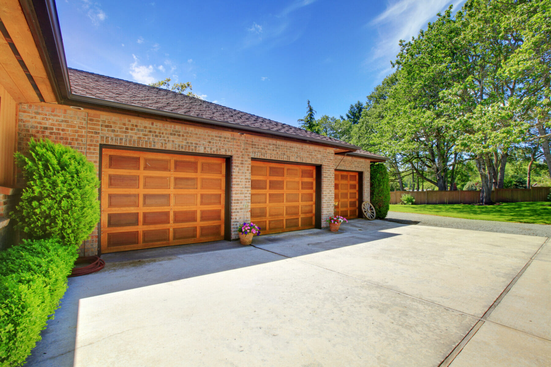 Large three bay garage with brown doors